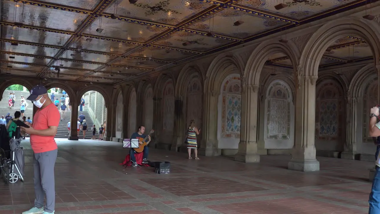 Musician playing guitar at an underpass in the Central Park of New York