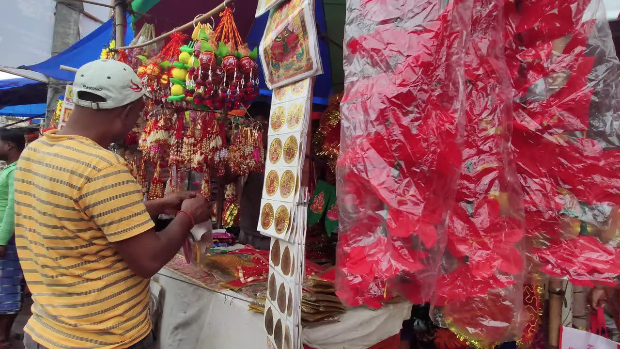 Indian man buying festival decorating items from roadside market for Diwali and chat puja