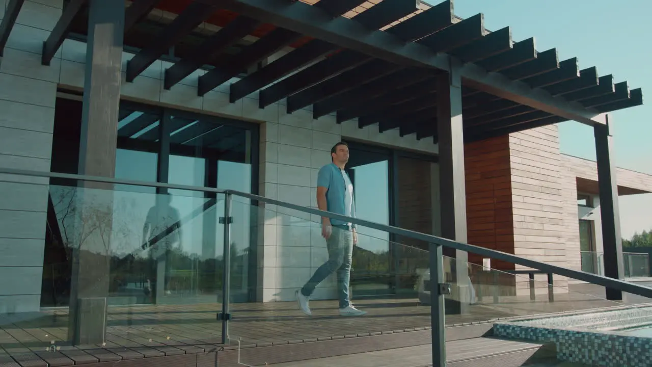 Happy man stretching on luxury house porch Leisure morning concept