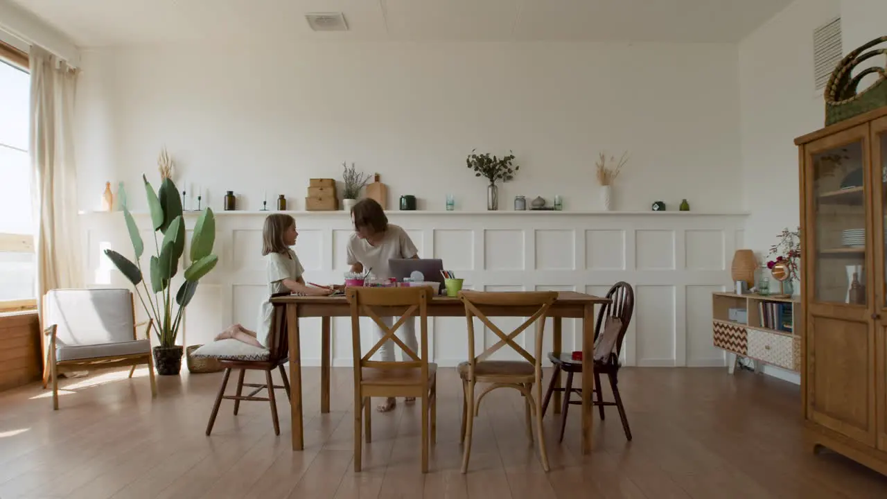 Wide Shot Of A Blonde Girl Doing Her Homework In Her Living Room