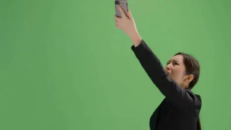 CU Angry woman trying find phone signal on green screen