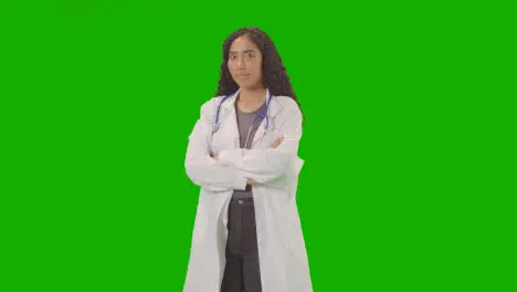 Studio Portrait Of Woman Wearing Christmas Jumper Against Green Screen Smiling At Camera