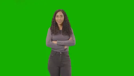 Three Quarter Length Studio Portrait Of Woman Against Green Screen Smiling At Camera 1