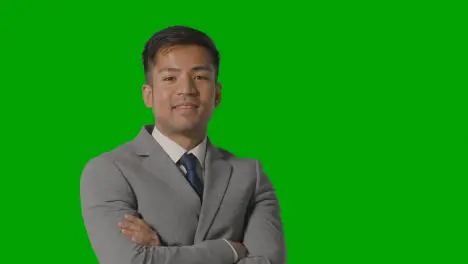 Portrait Of Businessman In Suit Against Green Screen Smiling At Camera 2