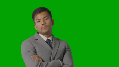 Portrait Of Serious Businessman In Suit Against Green Screen Looking At Camera 2