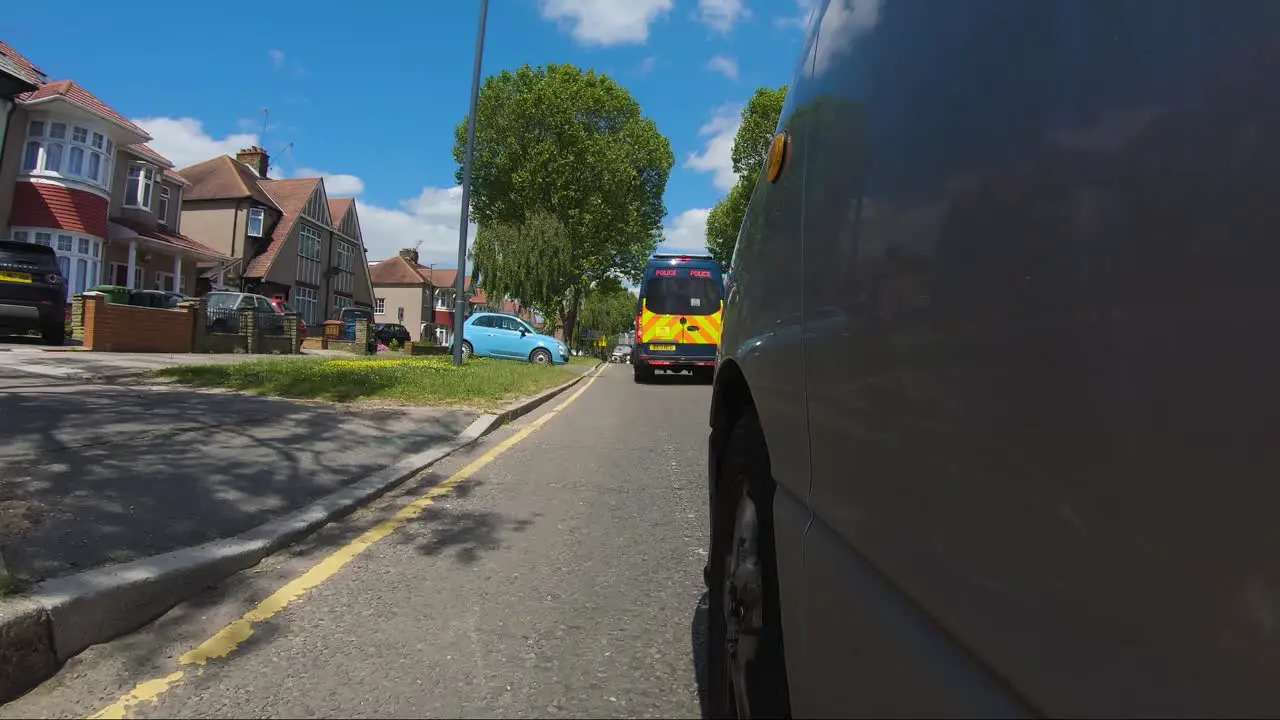 POV From Side Of Car Following Behind Police Van On Imperial Drive A4090 In Harrow London