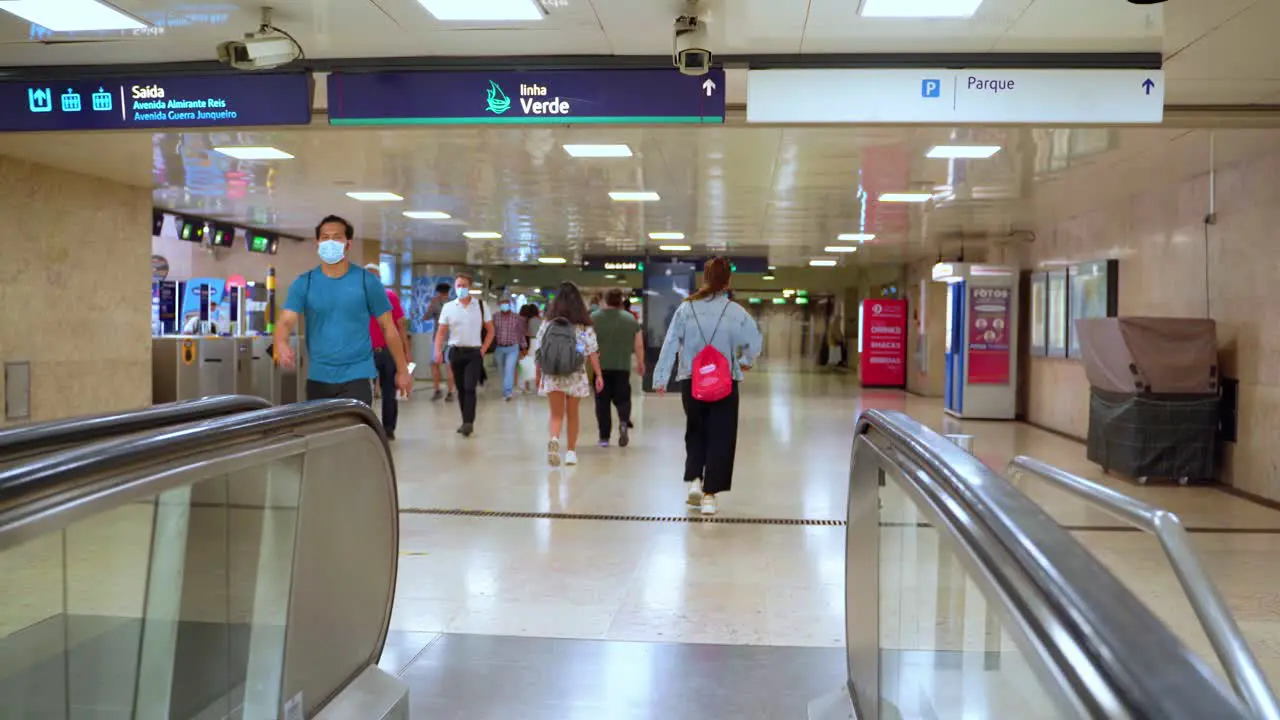 Masked commuters inside the metro station in Porto Portugal during the COVID-19 pandemic