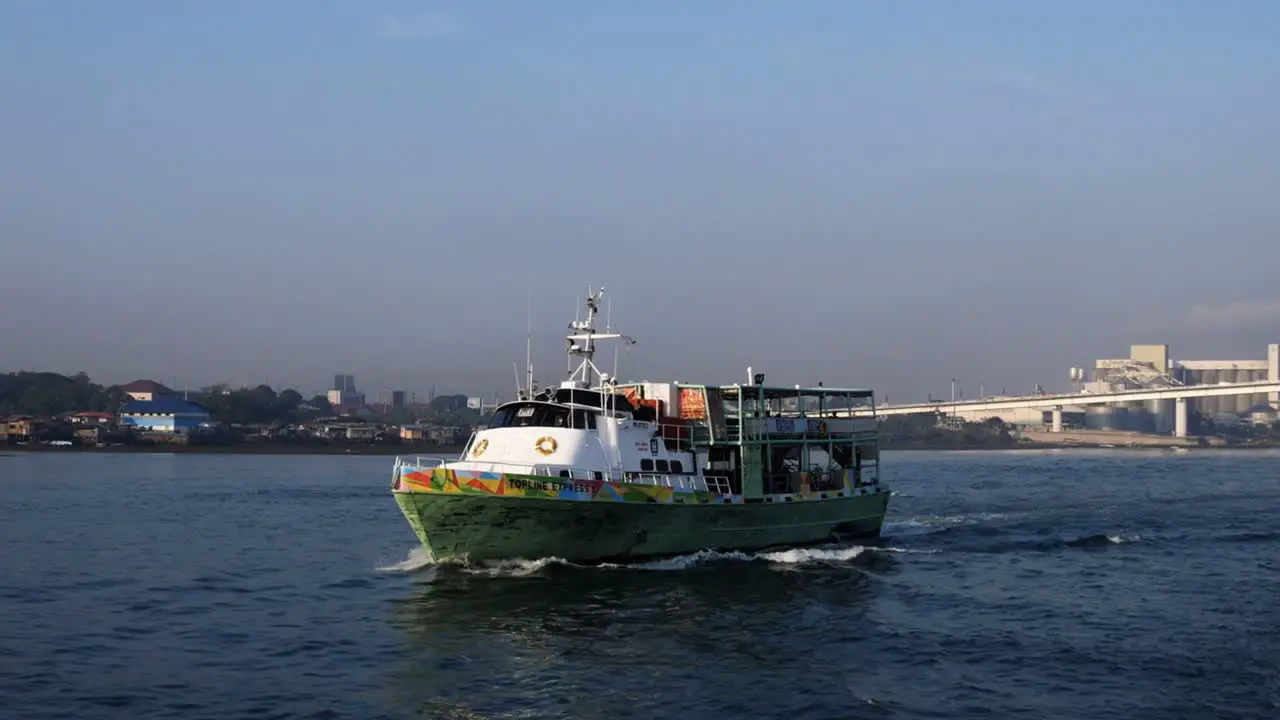 A small ferry sailing along Mactan Channel which separates Mactan and Cebu islands in Central Visayas Philippines