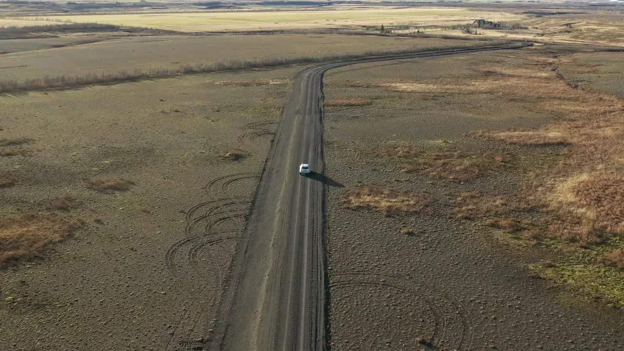 Drunk driver driving on a dirt road drowsy driver going off road aerial back view