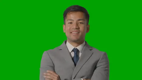 Portrait Of Businessman In Suit Against Green Screen Smiling At Camera 1