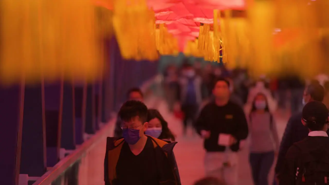 Chinese commuters are seen walking through a pedestrian bridge decorated with Chinese red lanterns hanging from the ceiling to celebrate the Chinese Lunar New Year festival in Hong Kong