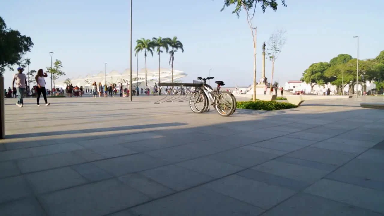 Bikes parked bikes and people going back home at Praca Maua at sunset in the center of Rio de Janeiro Brazil on a Sunday afternoon