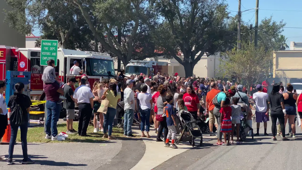 Crowd panning shot of The Florida Fire Sprinkler Association performing an on site education program on fire sprinklers saving lives Florida