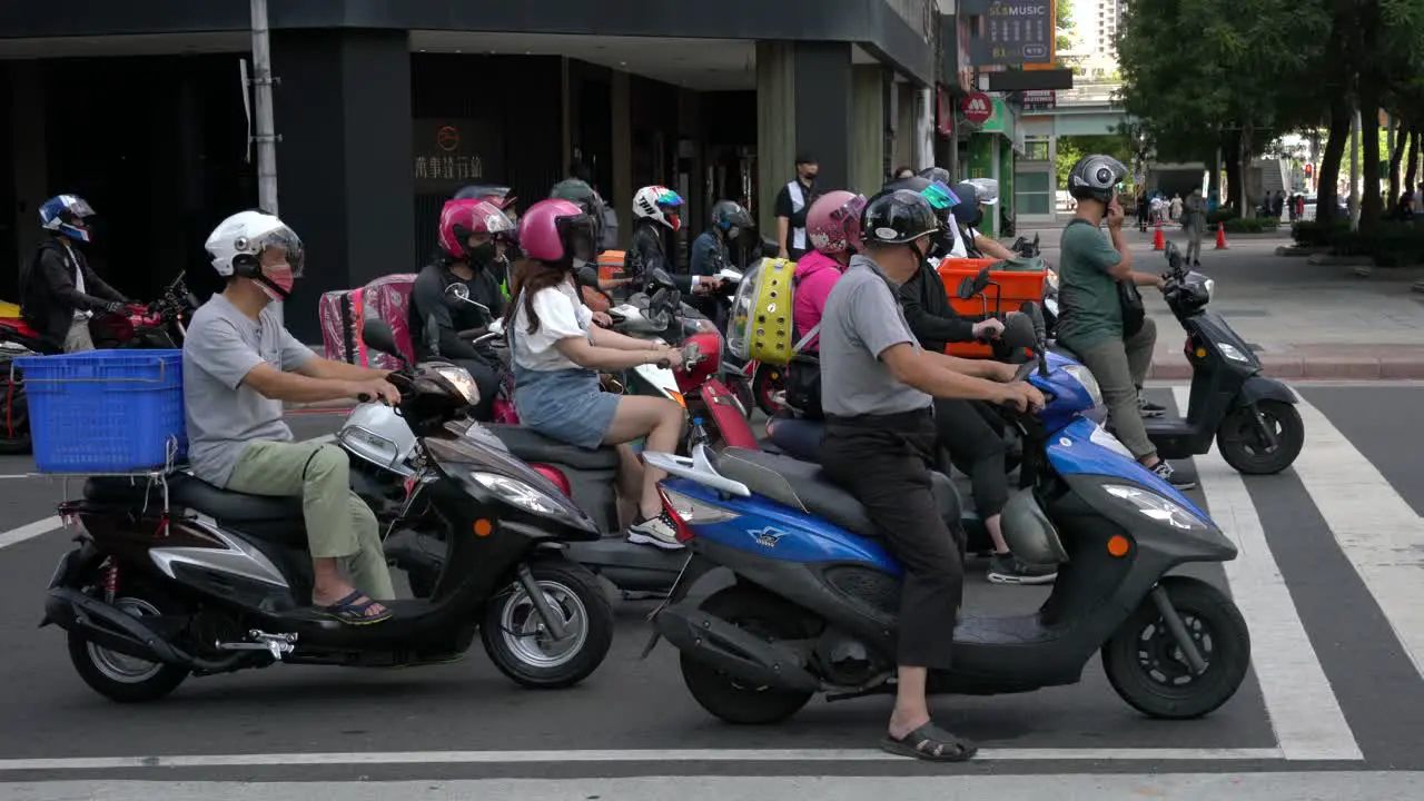 Motorcyclists waiting patiently at the traffic junction in Taipei Taiwan