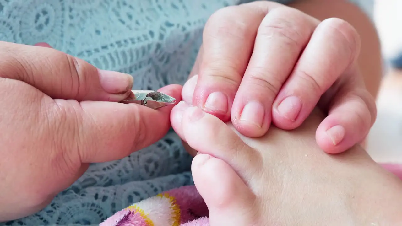 Pedicurist master making pedicure cutting cuticle with nail tongs on client's toes in a beauty salon-3