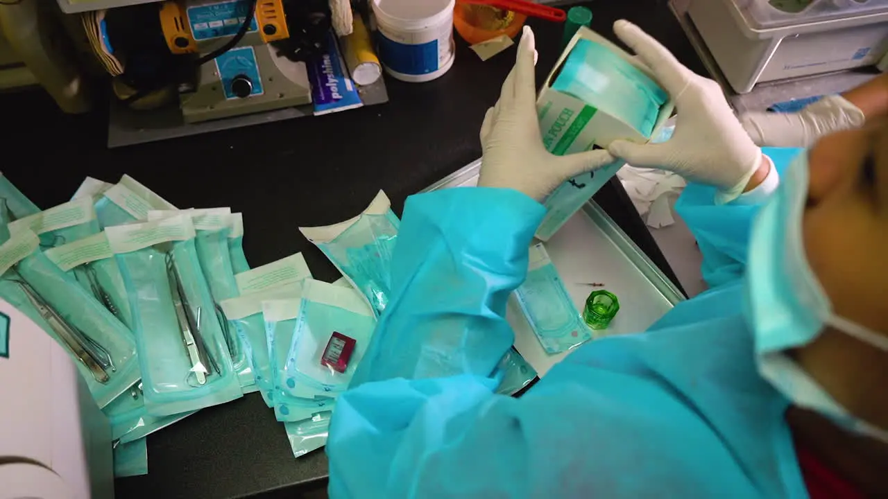 Over shoulder static shot of dental nurses preparing clean tools for storage