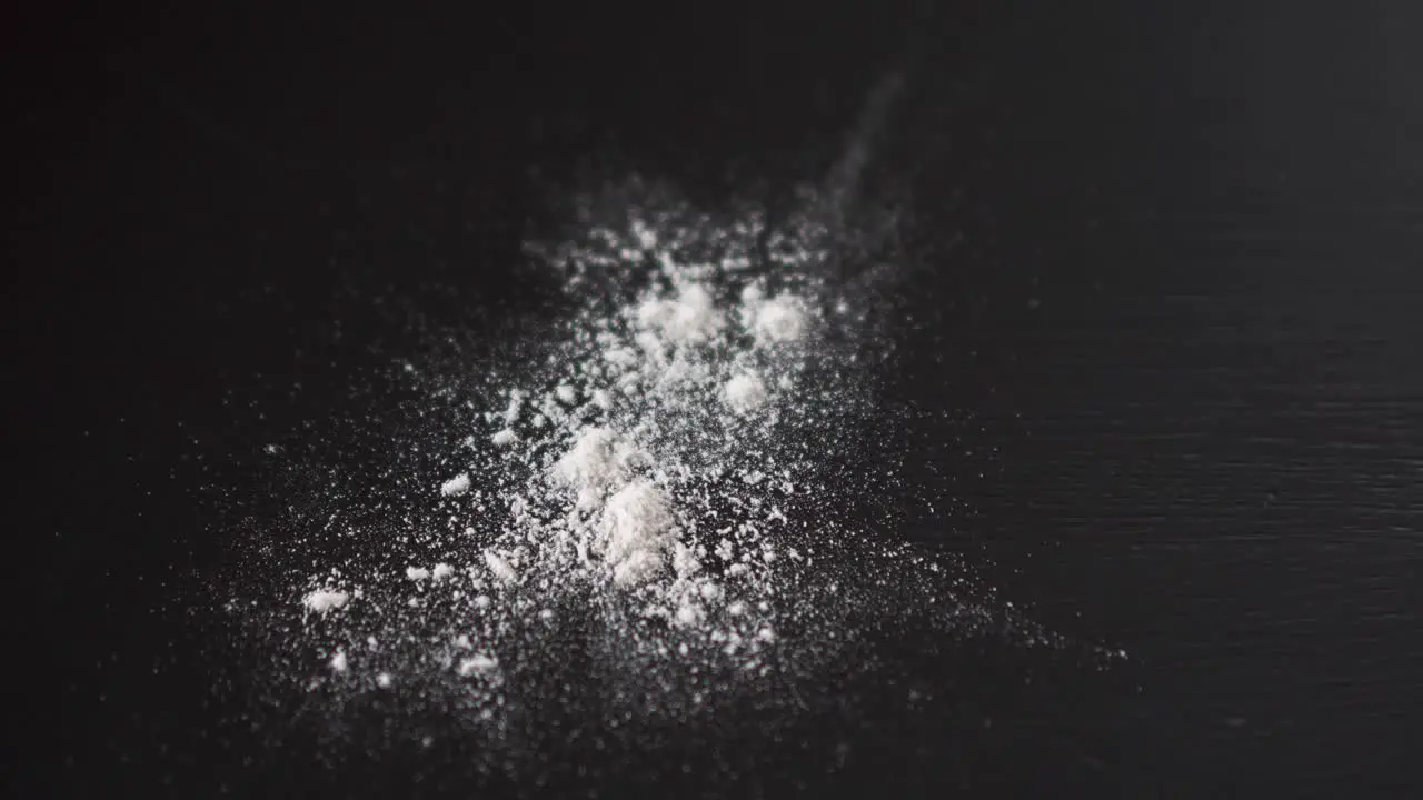 White powder falling on top of a table crushed pills