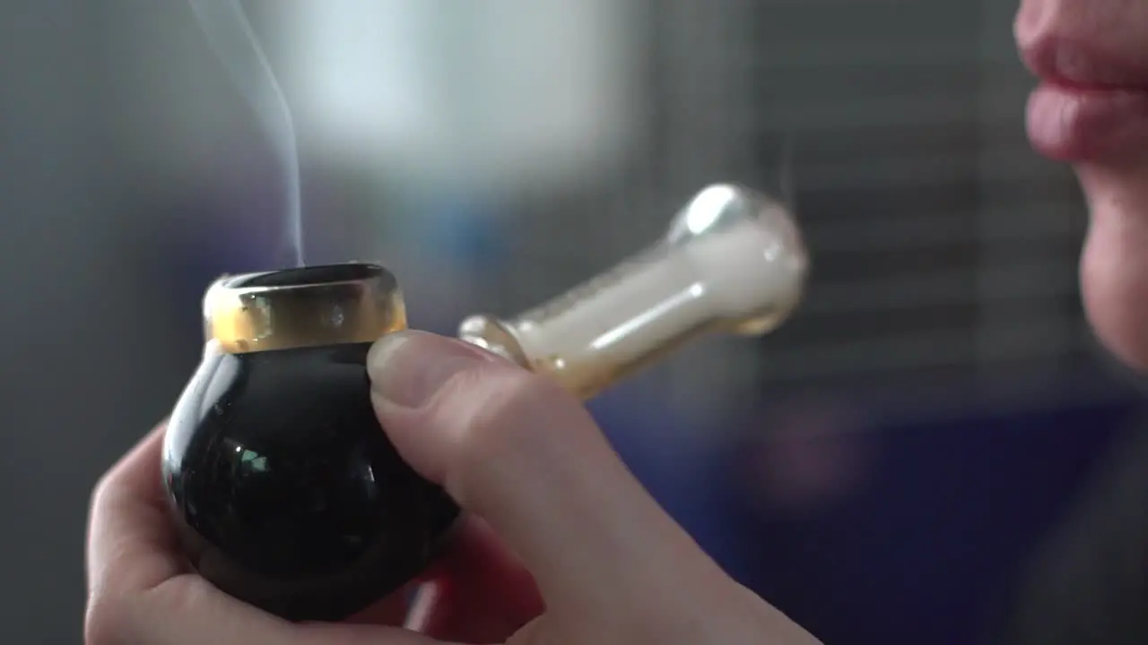 Close Up Of Smoking Pipe With Medical Marijuana Held By Female Hand