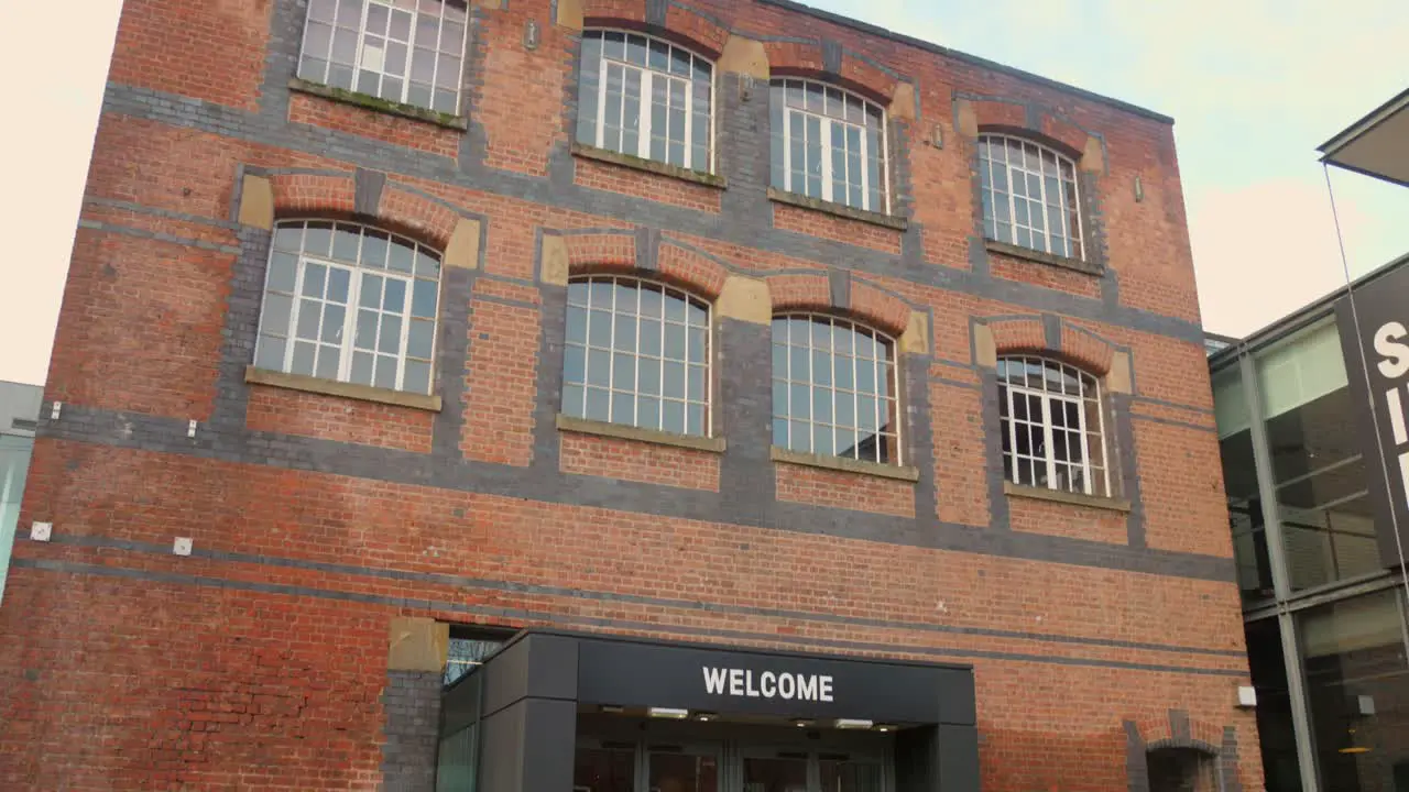 Low angle profile view of exterior architecture of vintage Science and Industry Museum during cold daytime in Manchester England