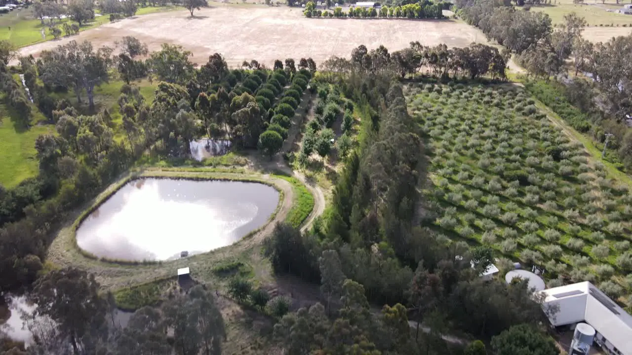 Drone aerial pan from organic permaculture to arid agricultural land