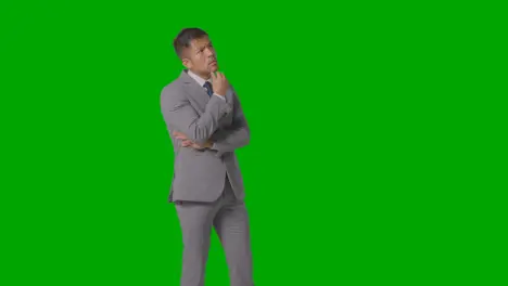 Three Quarter Length Shot Of Serious Businessman In Suit Thinking Against Green Screen 1