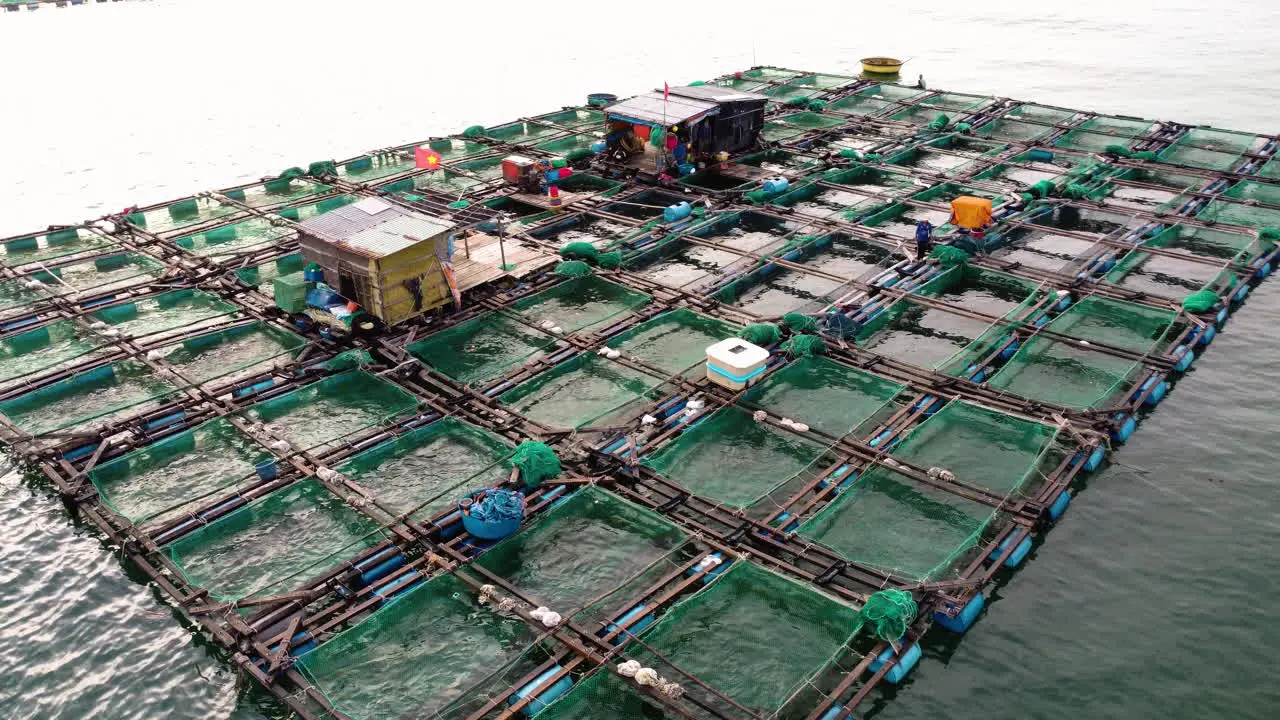 Commercial fish farm in ocean marine pens to farm fish