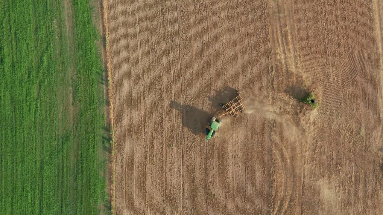 Farming Tractor on Agricultural Dirt Field Aerial Topdown Drone View