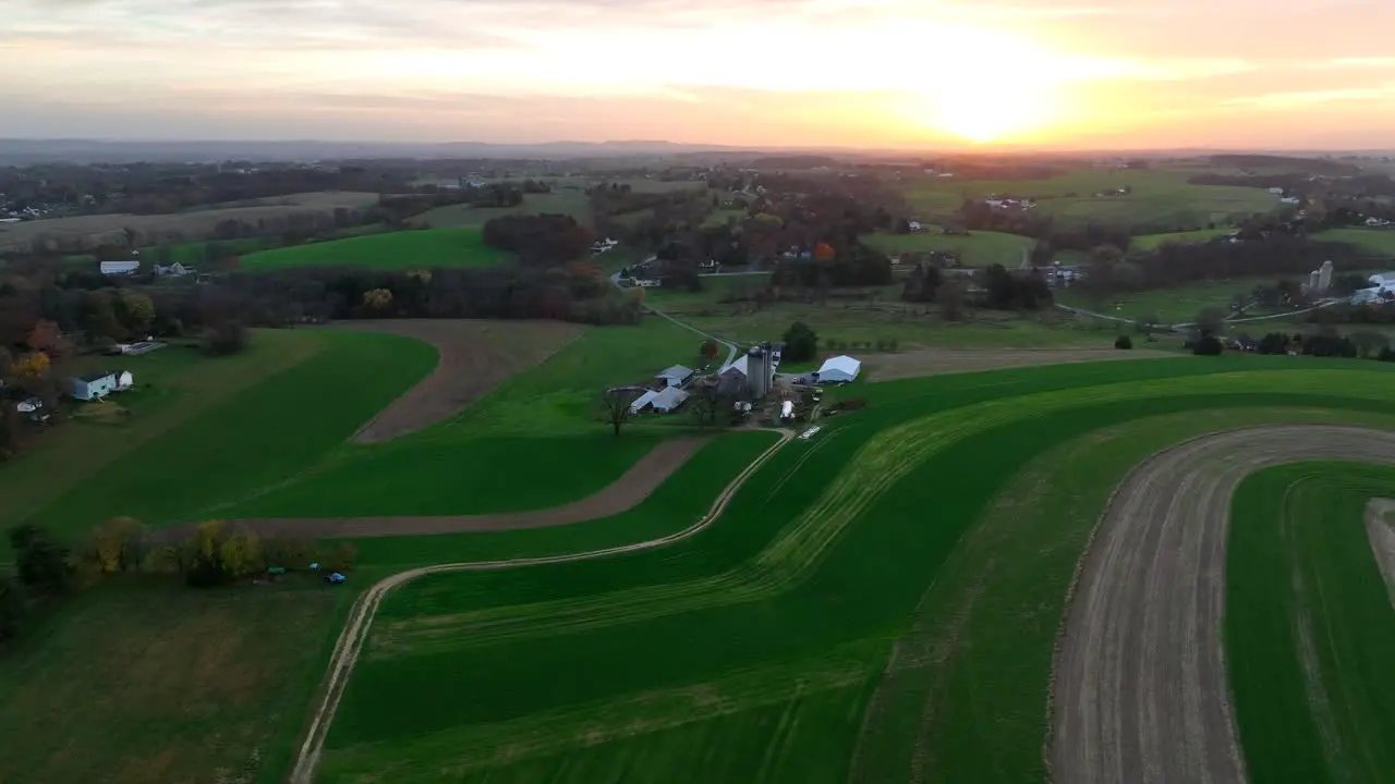 Aerial of contour farming and crop rotation theme with American farmland at sunset