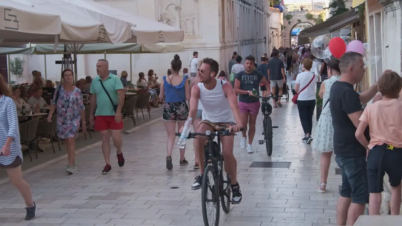 Zadar old town and summer vibes with pedestrians and a women selling balloons