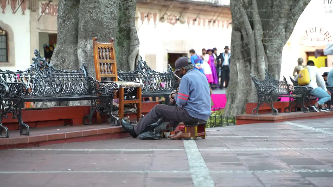 Old Man Shoe Shiner on Square in Taxco Mexico Authentic Scenery Slow Motion