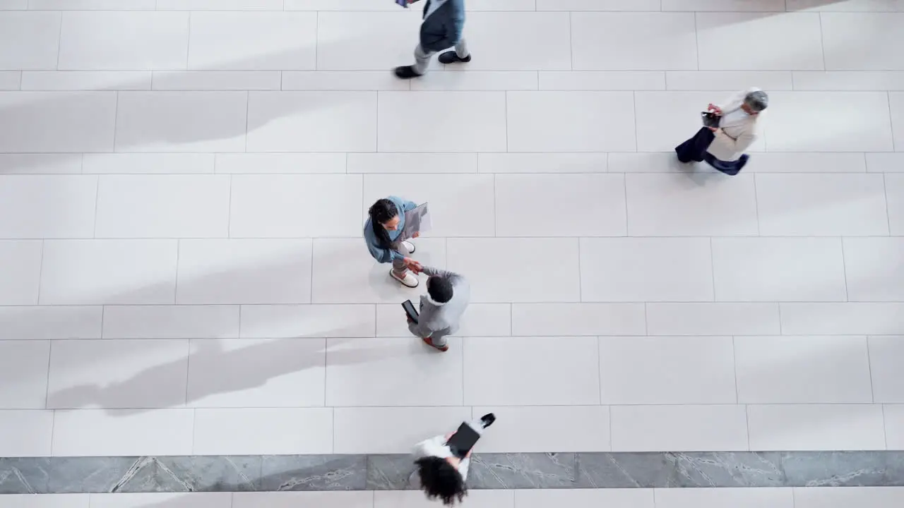 Above office and business people with a handshake