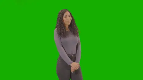 Portrait Of Woman Against Green Screen Smiling And Laughing At Camera 1