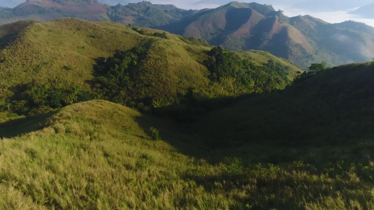 Aerial Fly Over Shot Of A Woman Hiker On Top Of A Mountain