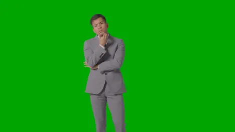 Three Quarter Length Shot Of Serious Businessman In Suit Thinking Against Green Screen 2