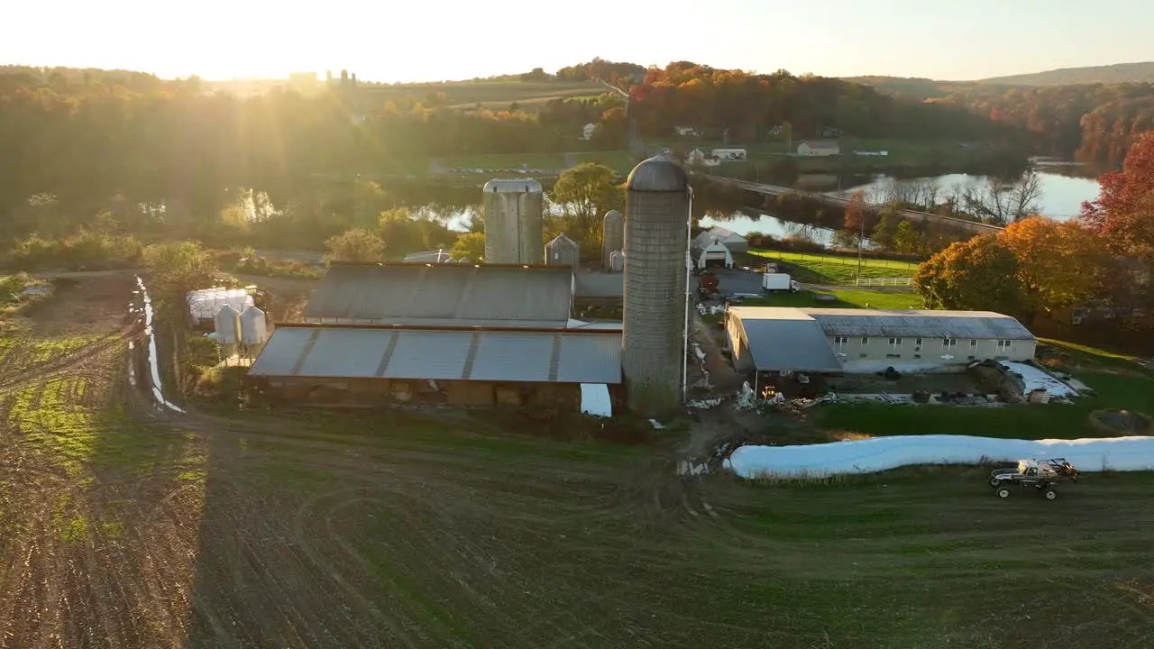 American farm beside rural lake at autumn sunset