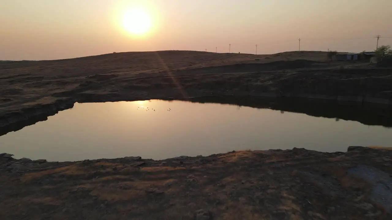 sunset mining site lake ducks in the pond drone shot