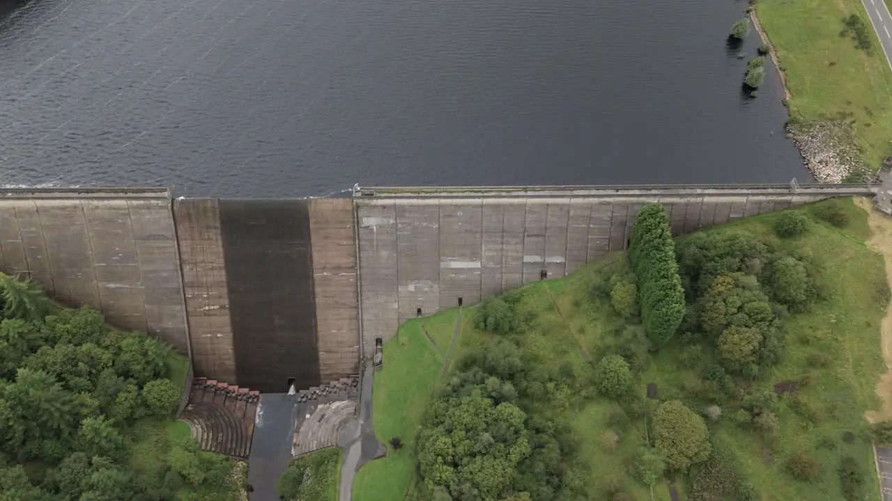 Booth wood reservoir aerial view dolly across concrete dam spillway and fresh water lake West Yorkshire