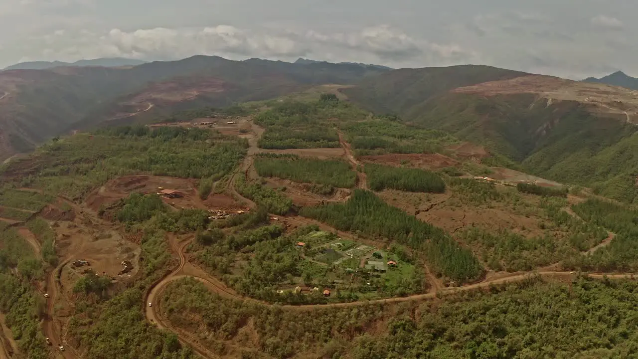 Tilt up reveal of a large open pit nickel mine in the philippines operated by Sumimoto and Nickel Asia