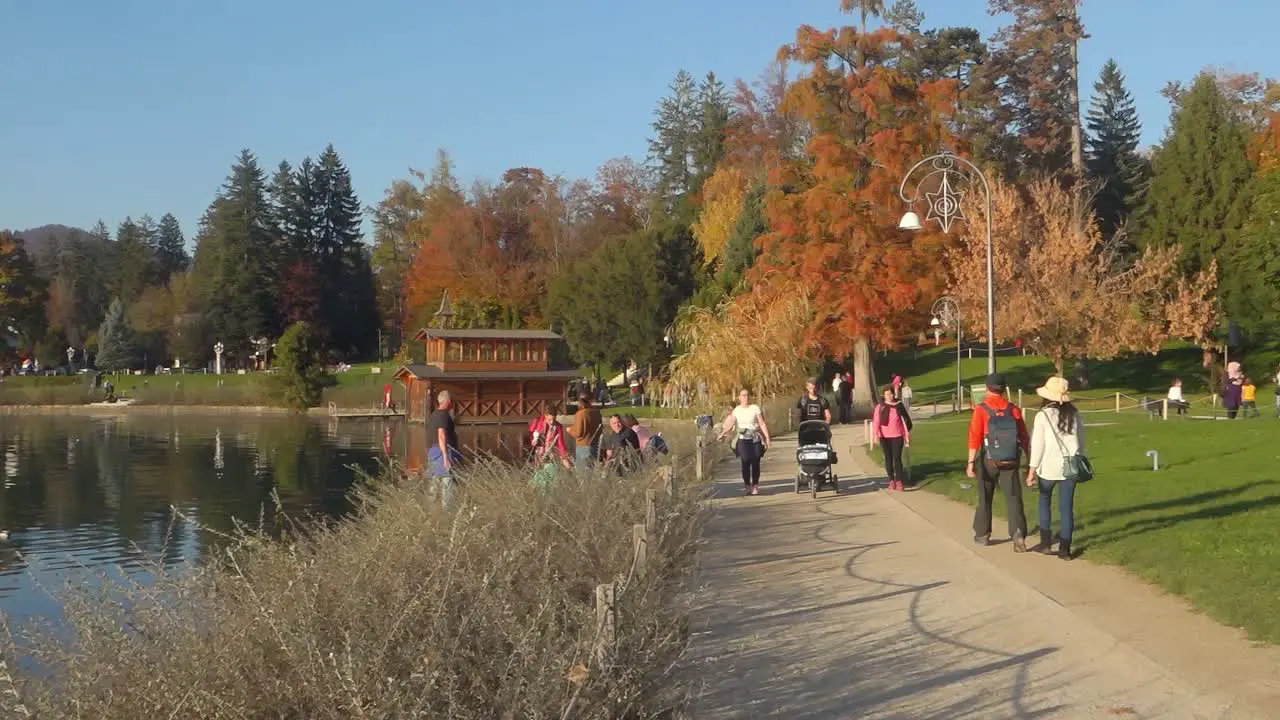 People on walkpath on the shore of lake Bled Slovenia