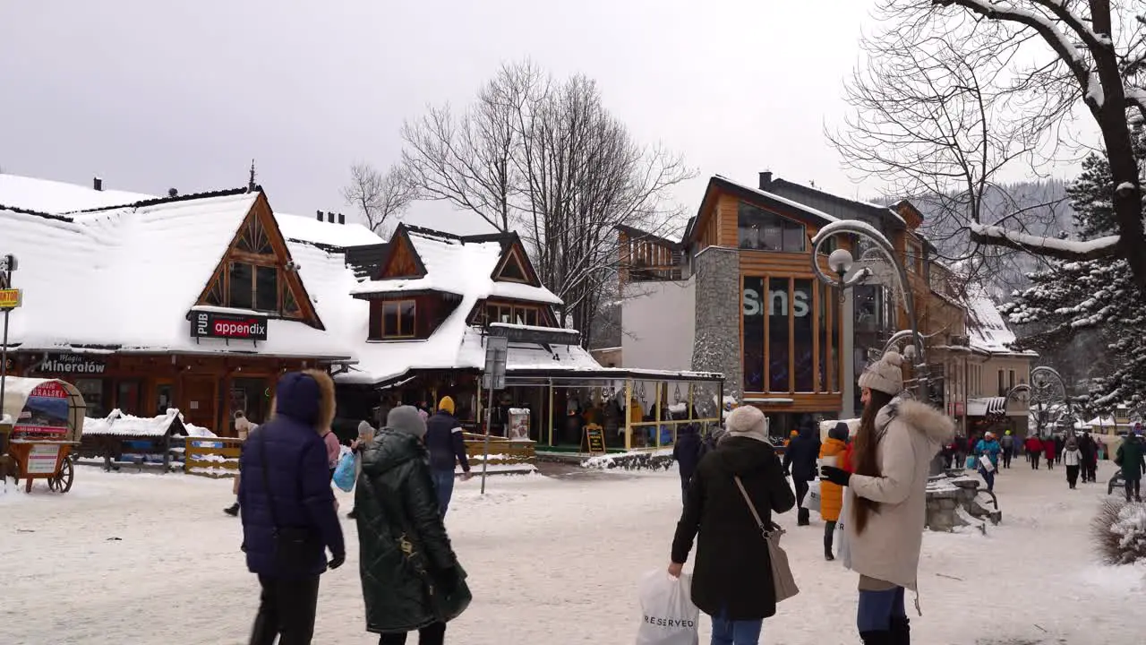 People outside in famous Polish winter resort town Zakopane with much snow