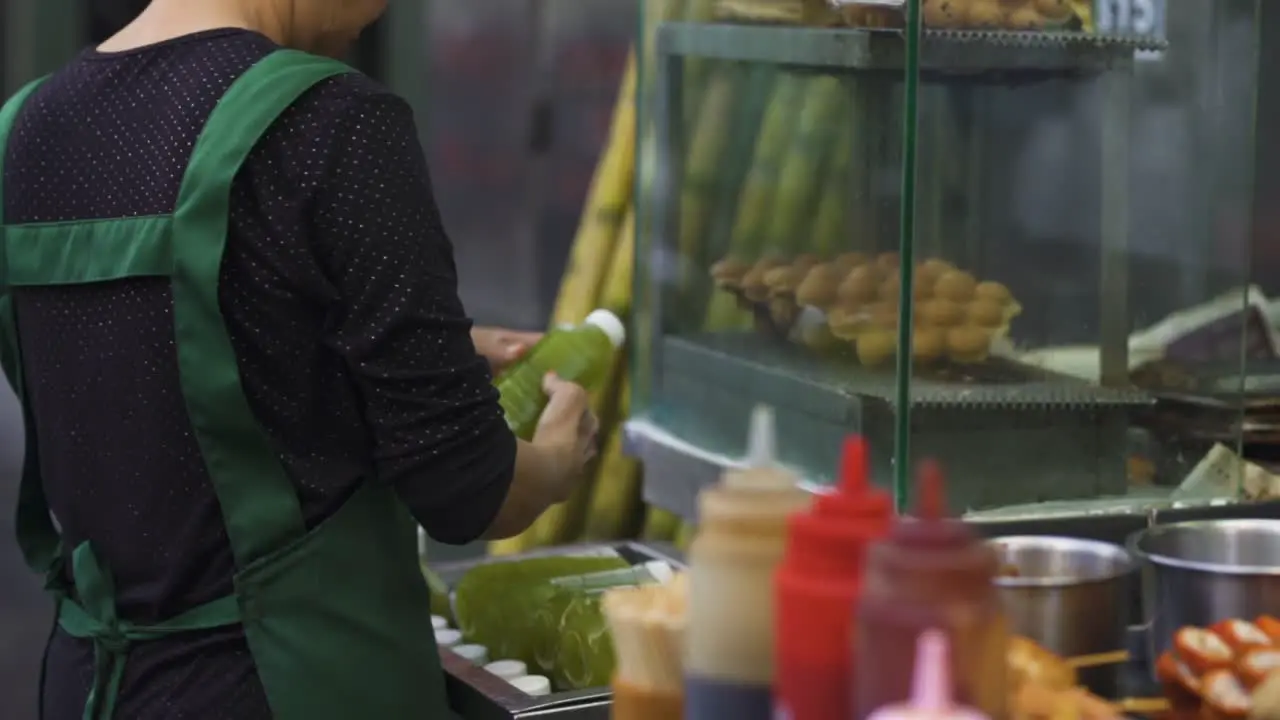 street food market stand asiatic woman frying tasty crispy food