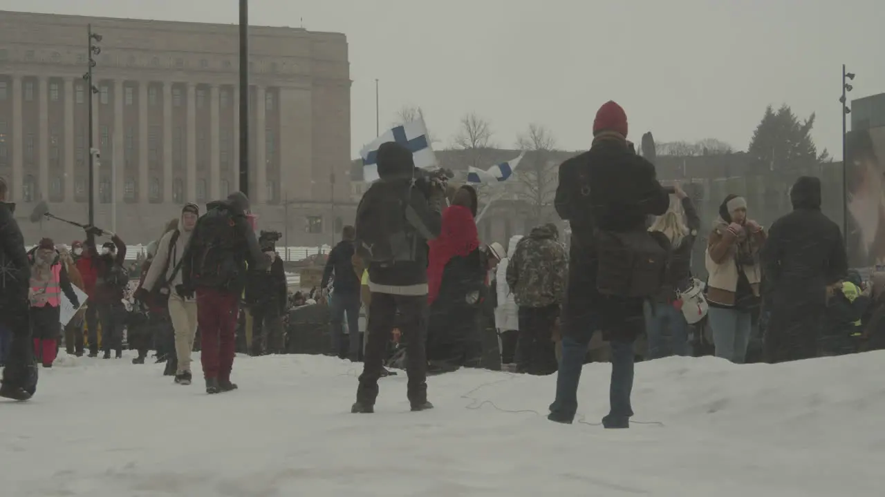 Reporters filmed a large group of protesters on a cold winter day in Finland