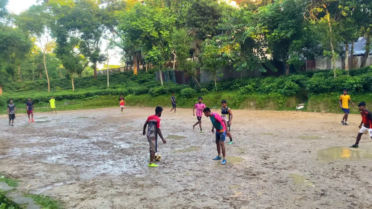 Locals Playing Soccer On Muddy Field In Sylhet