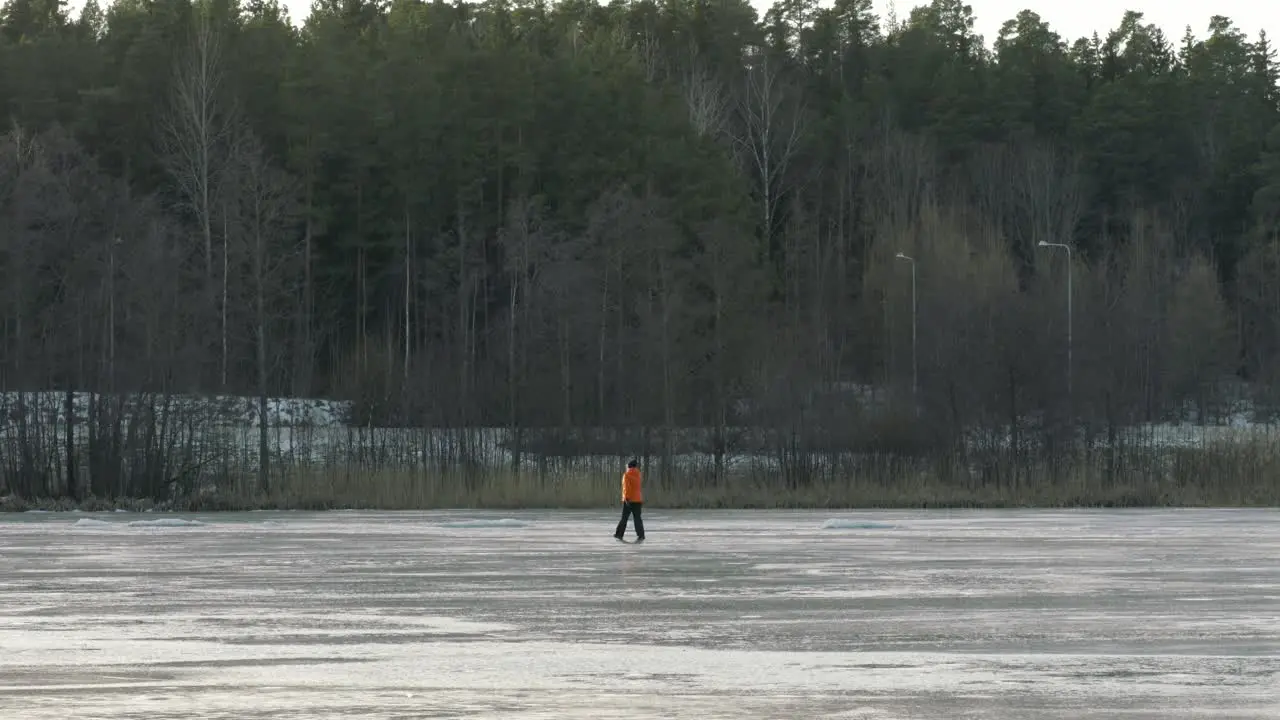 Woman walking across a frozen lake