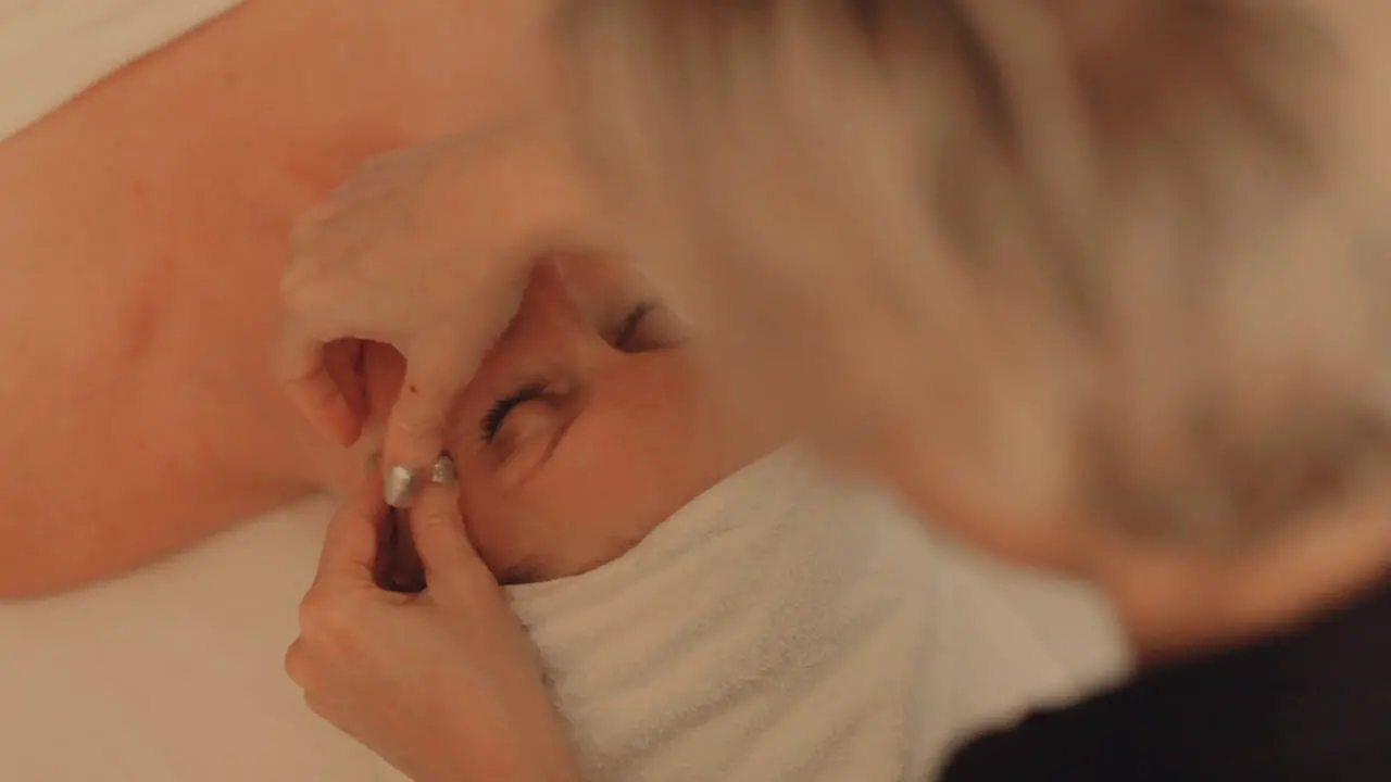 Beautiful woman getting her face massaged