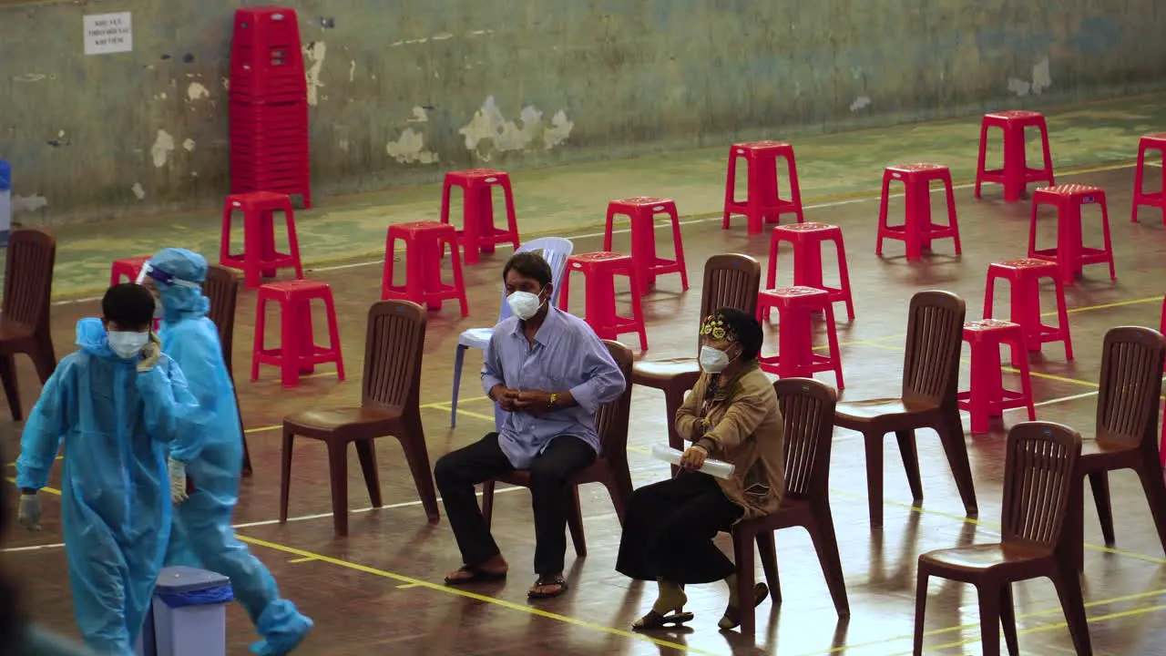 Frontline workers and foreigner beneficiaries at waiting area of vaccination site