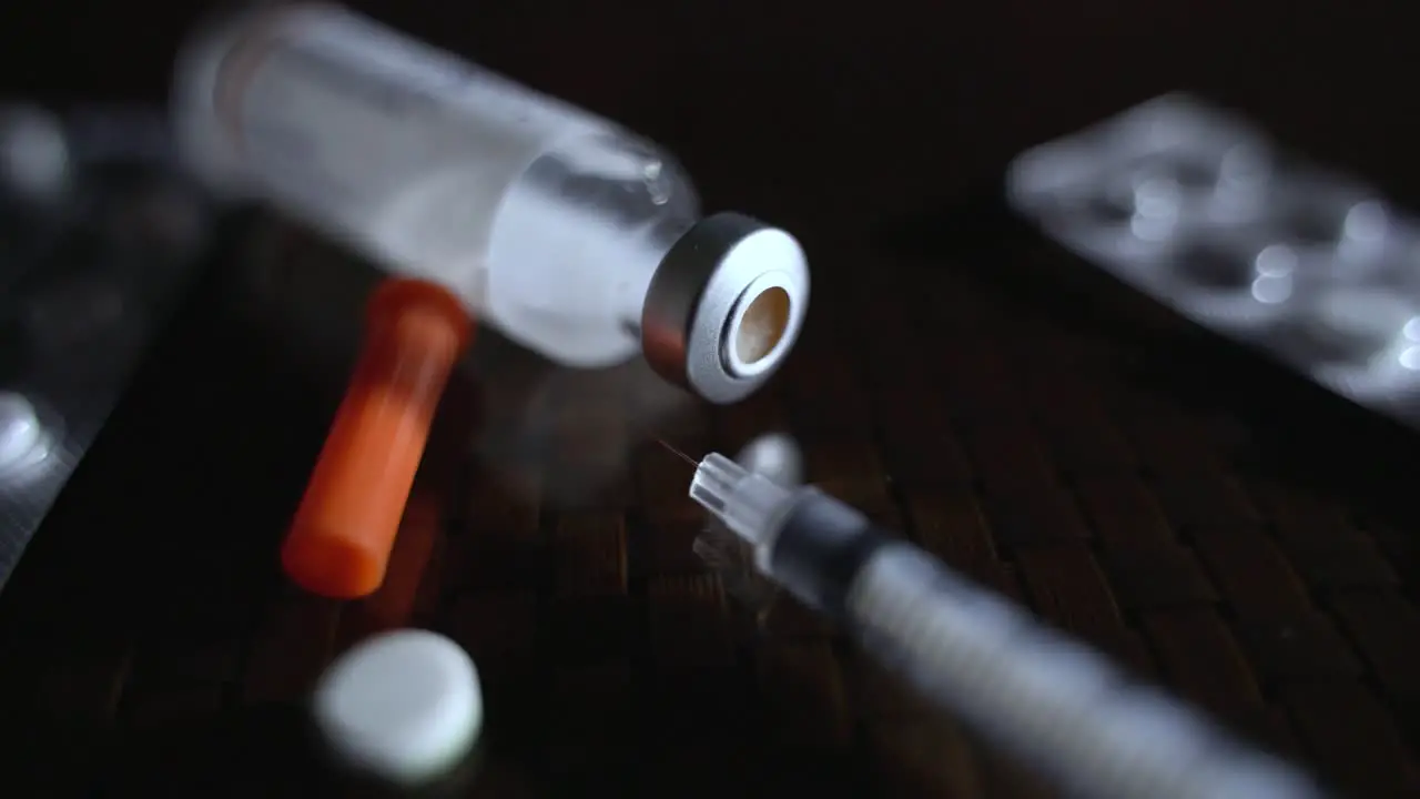 Closeup Of Vial Syringe And Prescription Medical Pills