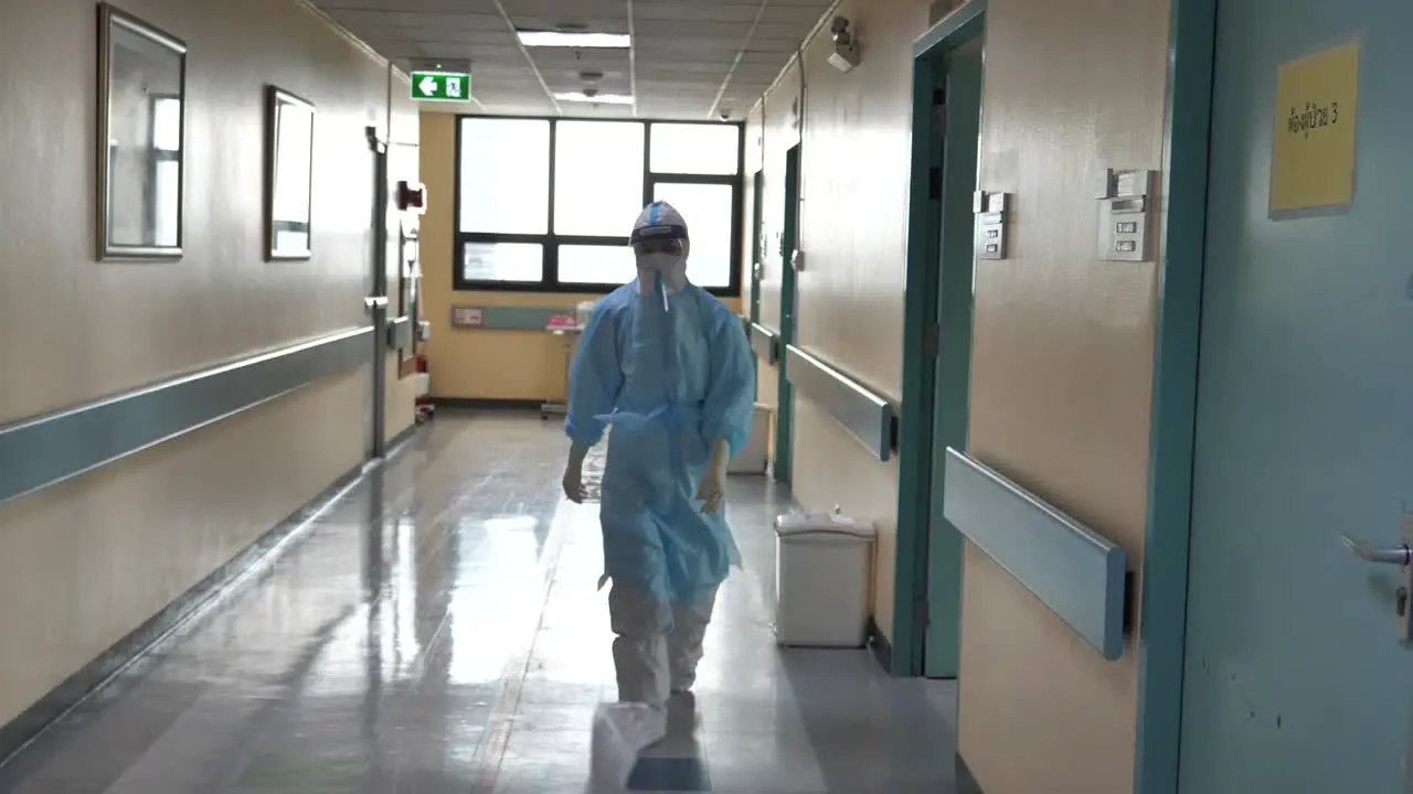 Medic Wearing Full PPE Walking In COVID-19 Hospital Hallway