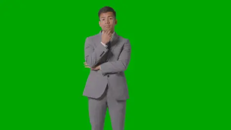 Three Quarter Length Shot Of Serious Businessman In Suit Thinking Against Green Screen 3