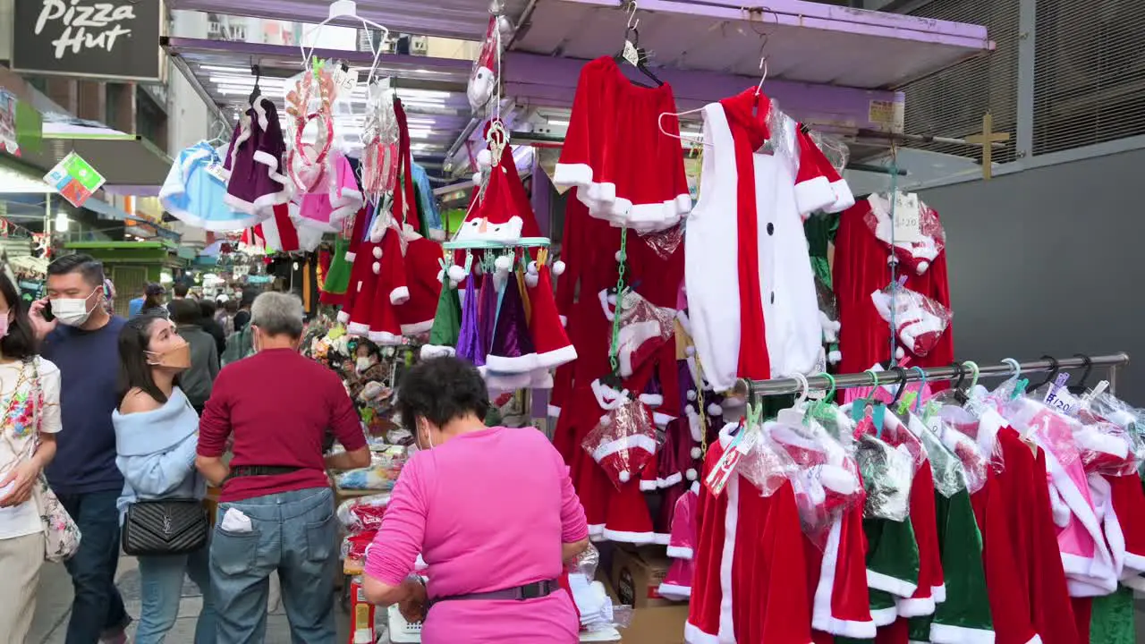 A street vendor is seen organizing Christmas merchandise for sale such as hats ornaments and costumes in Hong Kong